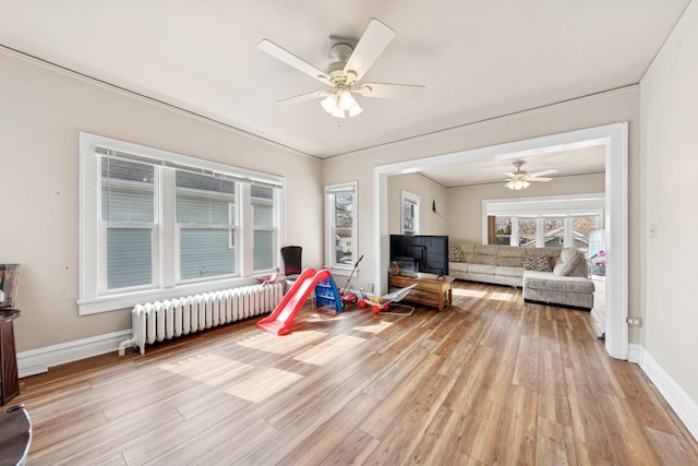 123 Philippa Ave, Waukegan, IL 60085 - interior space with a ceiling fan, baseboards, radiator heating unit, and light wood finished floors