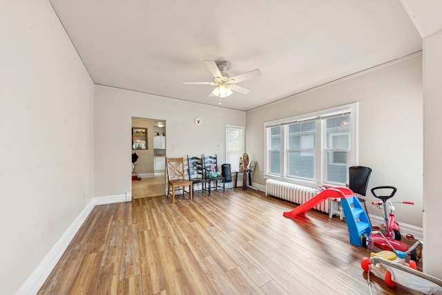 123 Philippa Ave, Waukegan, IL 60085 - rec room featuring radiator, baseboards, ceiling fan, and light wood-type flooring