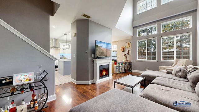 514 E Thornhill Ln, Palatine, IL 60074 - living area with a warm lit fireplace, visible vents, baseboards, and wood finished floors