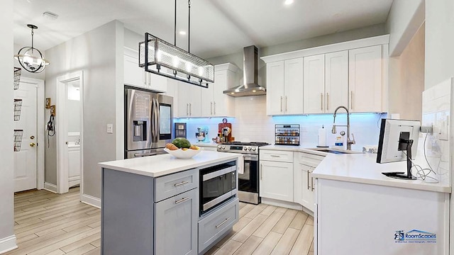 514 E Thornhill Ln, Palatine, IL 60074 - kitchen featuring tasteful backsplash, wall chimney exhaust hood, a sink, appliances with stainless steel finishes, and light wood finished floors