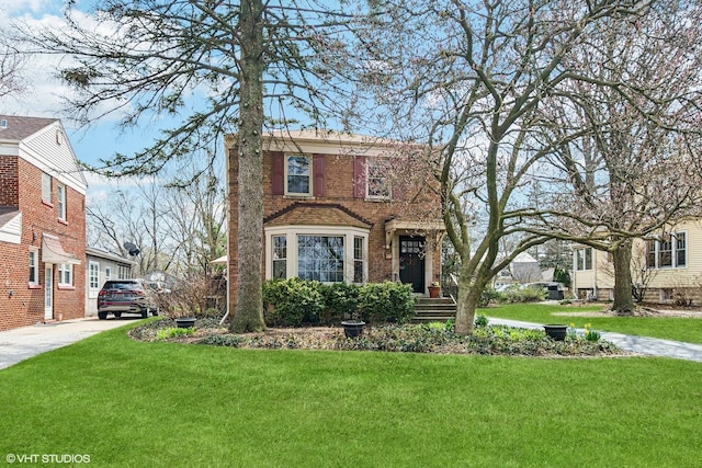 traditional home featuring concrete driveway and a front lawn