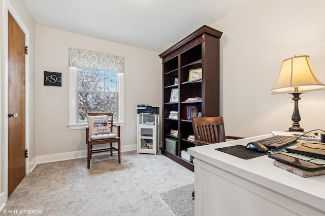 office area featuring baseboards and light colored carpet
