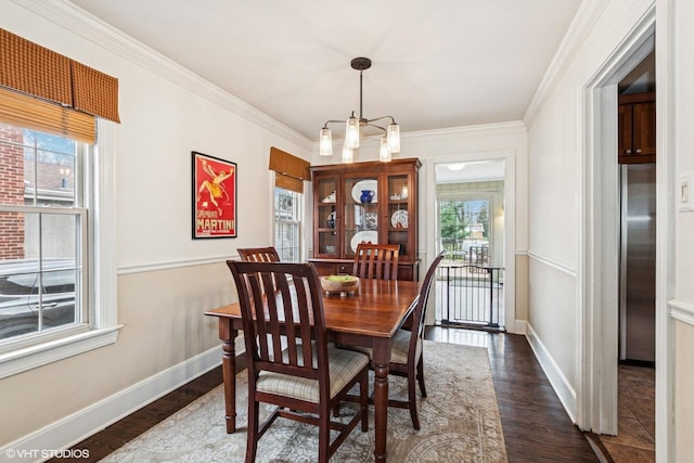 dining area with dark wood-type flooring, baseboards, and plenty of natural light