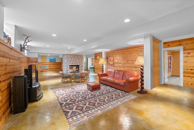 8673 Timber Ridge Dr, Burr Ridge, IL 60527 - living area with wood walls, concrete floors, a multi sided fireplace, and recessed lighting