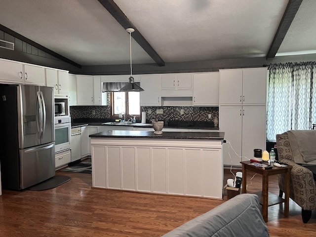 kitchen featuring backsplash, white cabinets, appliances with stainless steel finishes, dark countertops, and dark wood-style floors