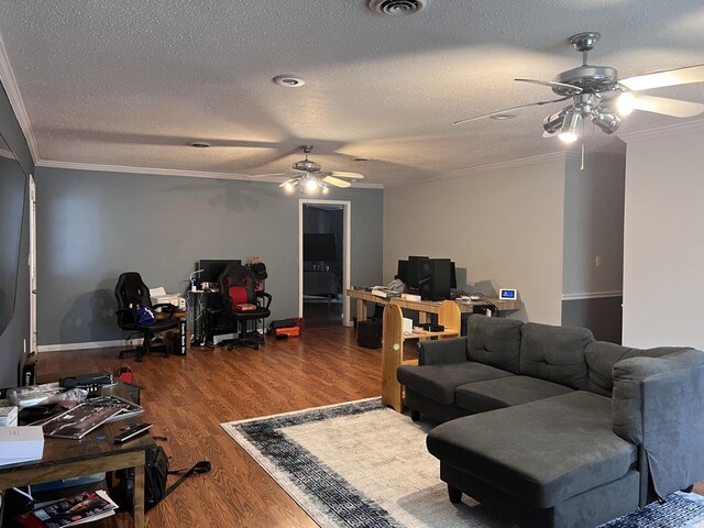 living area with crown molding, a ceiling fan, wood finished floors, and a textured ceiling