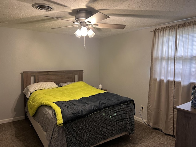 carpeted bedroom featuring a textured ceiling, ceiling fan, baseboards, and visible vents