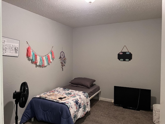 carpeted bedroom with a textured ceiling
