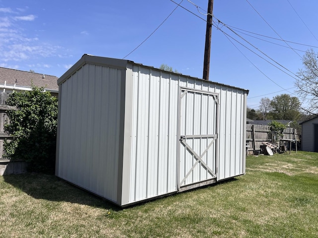 view of shed featuring fence