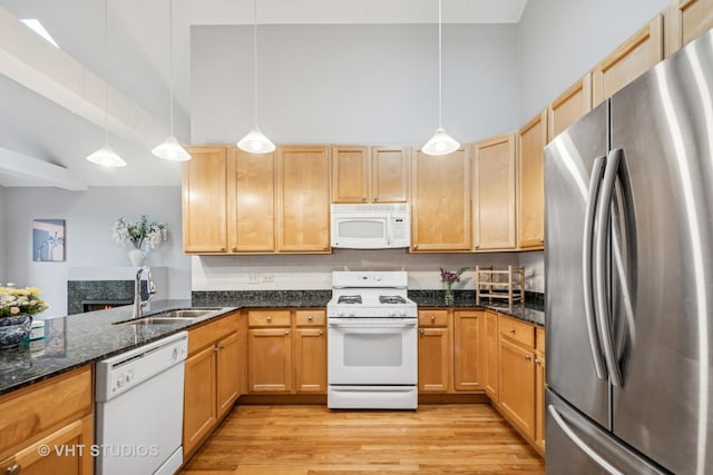 2336 W Harrison St Unit 4, Chicago, IL 60612 - kitchen with white appliances, a sink, light wood-type flooring, a high ceiling, and dark stone counters