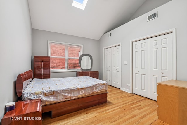 2336 W Harrison St Unit 4, Chicago, IL 60612 - bedroom with two closets, wood finished floors, a skylight, and high vaulted ceiling