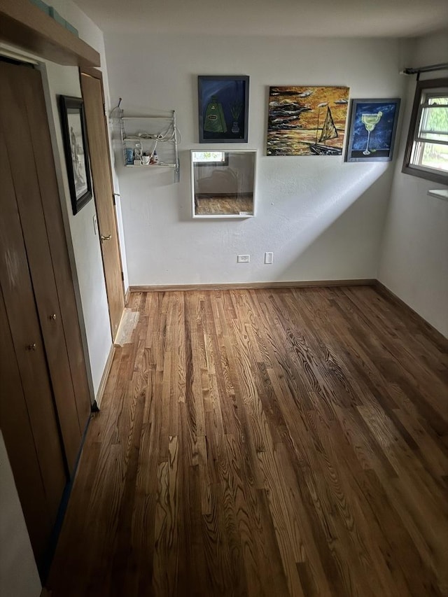 corridor featuring wood finished floors