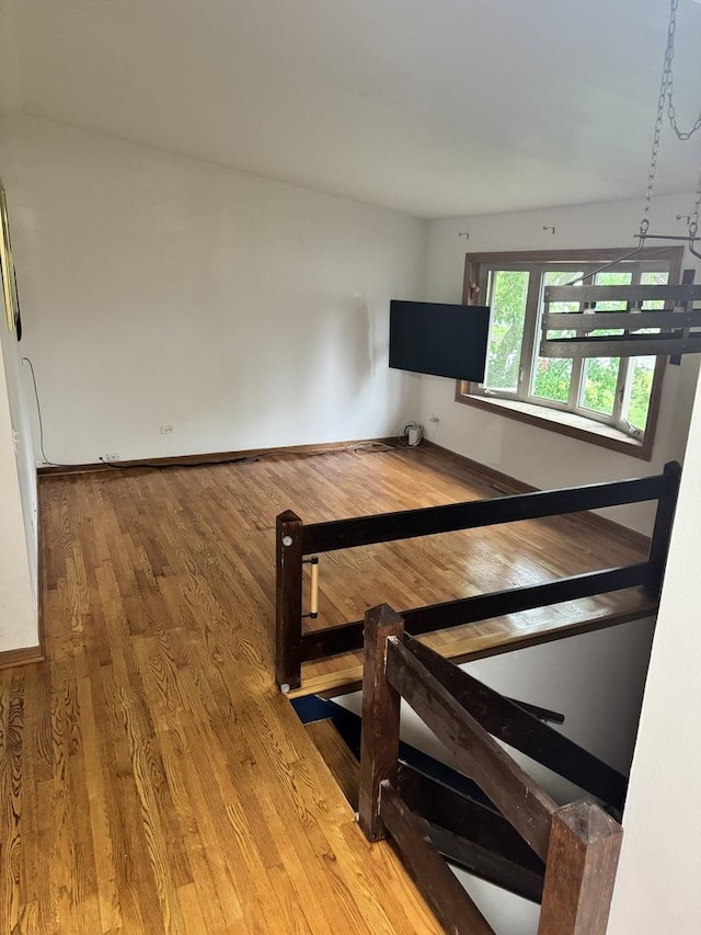 bedroom featuring light wood finished floors and baseboards