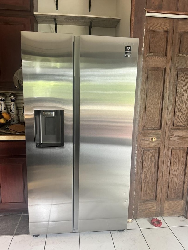 kitchen with stainless steel fridge and light tile patterned floors