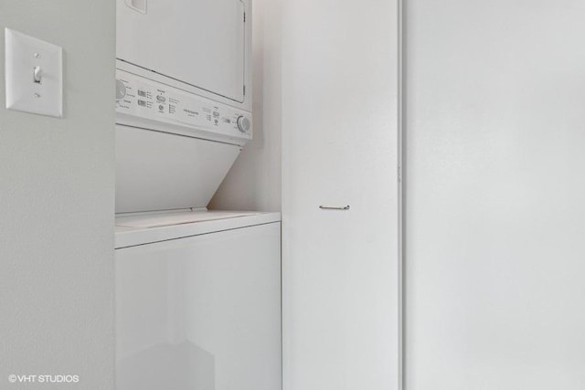 laundry room featuring stacked washing maching and dryer and laundry area
