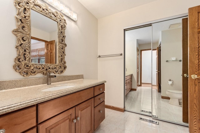 bathroom with visible vents, toilet, vanity, and tile patterned flooring