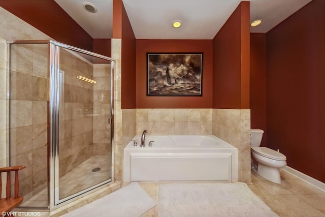 full bath featuring toilet, tile patterned floors, a garden tub, and a shower stall