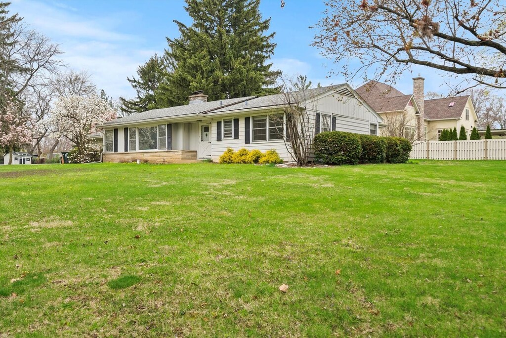 22W584 Ahlstrand Rd, Glen Ellyn, IL 60137 - exterior space featuring fence, a chimney, and a front yard
