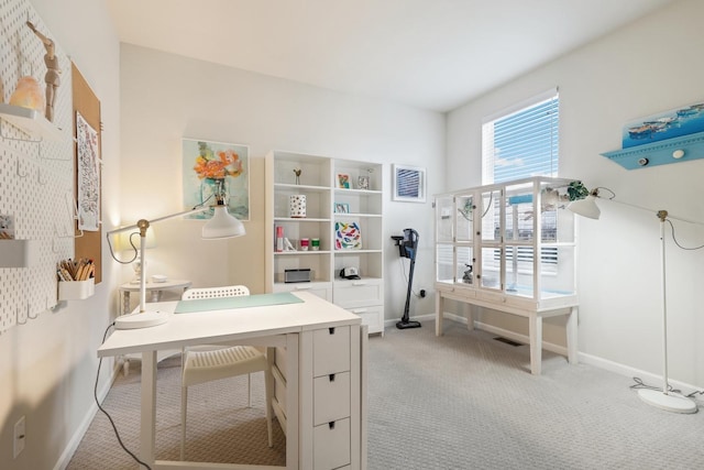 office featuring visible vents, baseboards, and light colored carpet