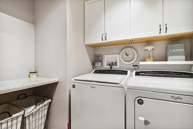 laundry room with washing machine and dryer and cabinet space