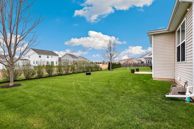 view of yard featuring fence and a residential view