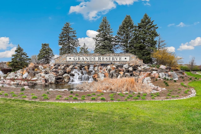 community / neighborhood sign with a yard