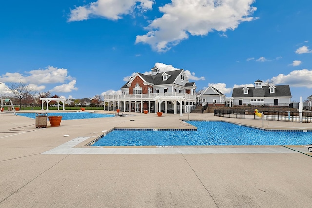 community pool with fence, a pergola, and a patio