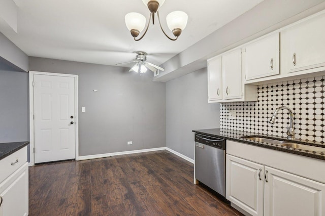 kitchen featuring white cabinets, decorative backsplash, stainless steel dishwasher, ceiling fan with notable chandelier, and a sink