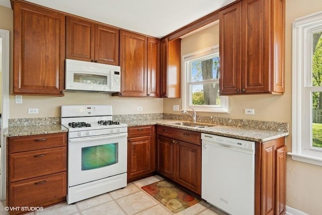 21 39th St, Downers Grove, IL 60515 - kitchen with white appliances, a sink, healthy amount of natural light, and brown cabinetry