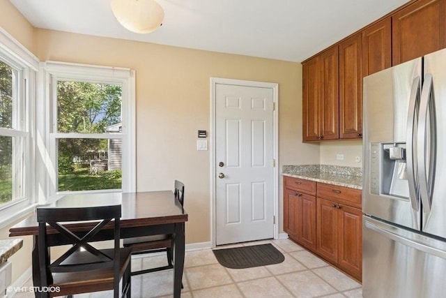 21 39th St, Downers Grove, IL 60515 - kitchen with stainless steel refrigerator with ice dispenser, brown cabinetry, and plenty of natural light