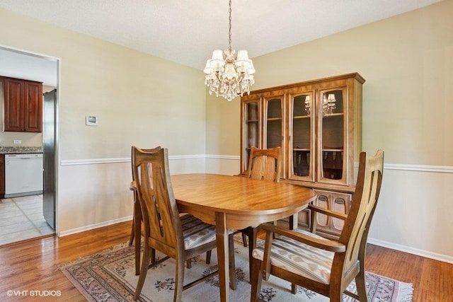 21 39th St, Downers Grove, IL 60515 - dining space featuring a chandelier, light wood-type flooring, and baseboards