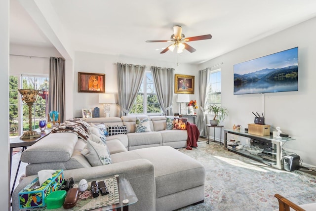 living area featuring a healthy amount of sunlight and a ceiling fan