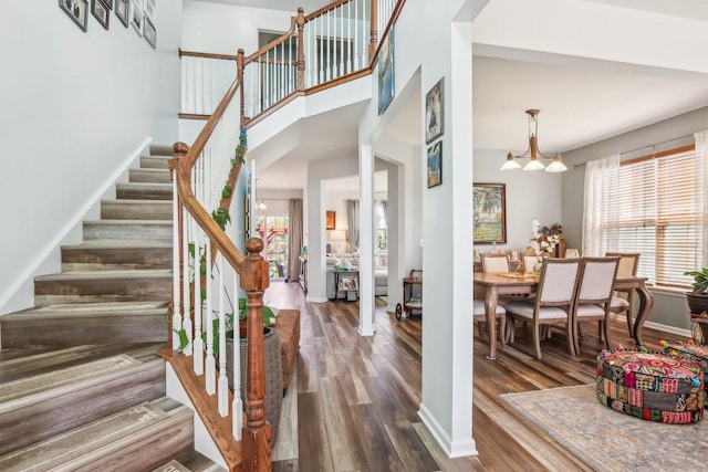 interior space featuring wood finished floors and a chandelier