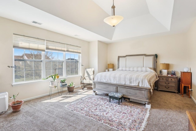 bedroom featuring a raised ceiling, carpet floors, visible vents, and baseboards