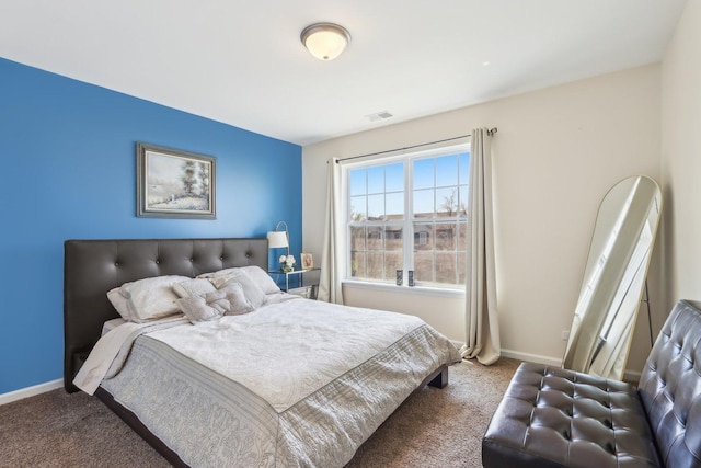 bedroom with baseboards, visible vents, and carpet