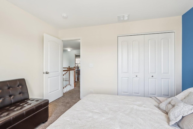 bedroom with a closet, visible vents, and carpet