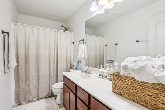 full bathroom with toilet and vanity