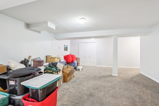 finished below grade area featuring baseboards and carpet flooring