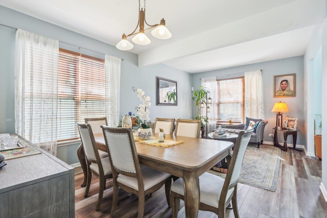 dining room with an inviting chandelier, wood finished floors, and baseboards