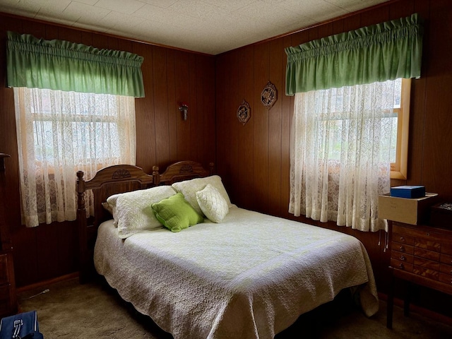 bedroom with carpet and wooden walls