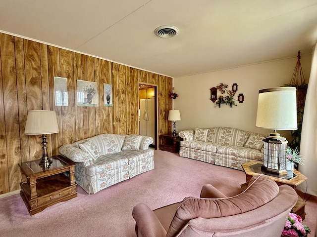 carpeted living room featuring wood walls and visible vents