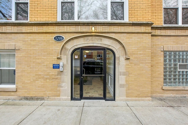 property entrance with brick siding
