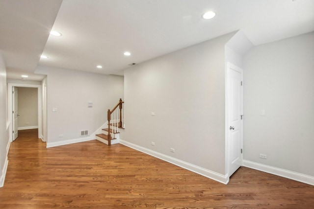 below grade area with stairway, light wood-type flooring, visible vents, and recessed lighting