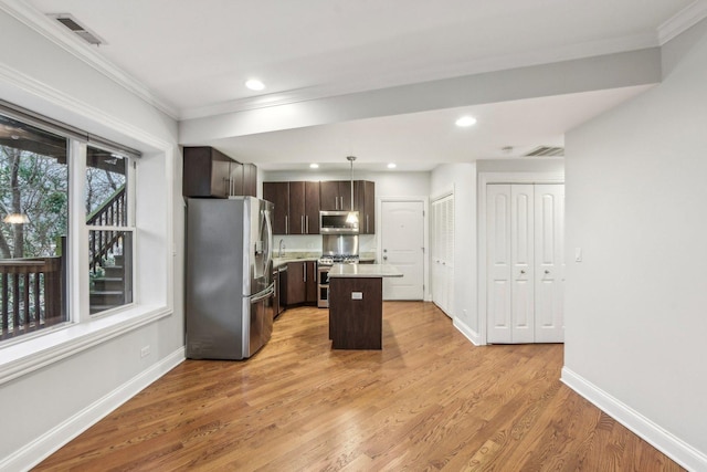 kitchen featuring dark brown cabinets, visible vents, appliances with stainless steel finishes, and crown molding