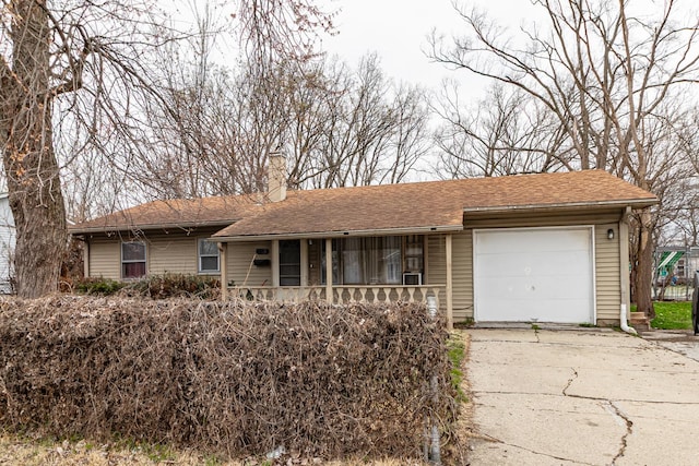 ranch-style home featuring a shingled roof, a porch, a garage, a chimney, and driveway