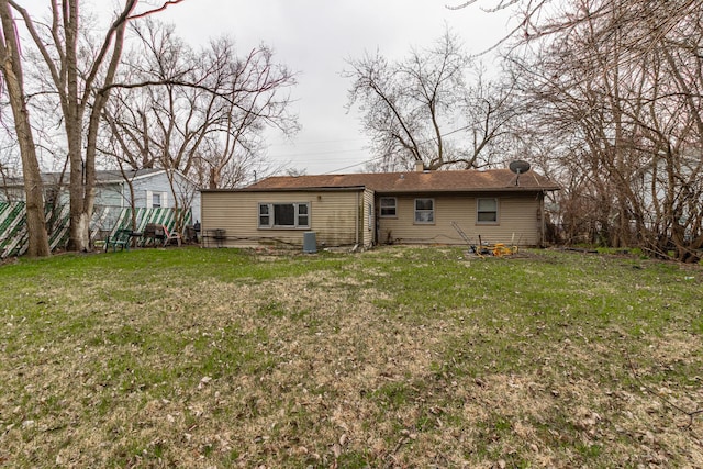 rear view of property with a lawn