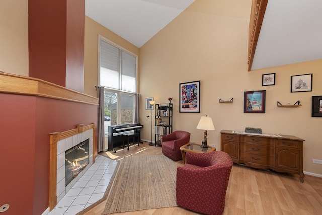 22W128 Butterfield Rd, Glen Ellyn, IL 60137 - living room with high vaulted ceiling, light wood finished floors, a tile fireplace, and baseboards