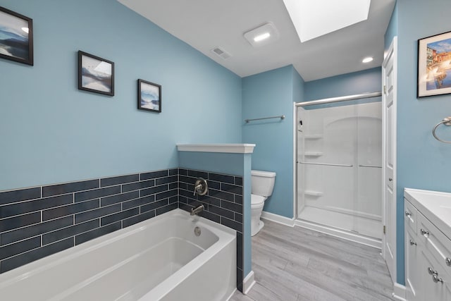 22W128 Butterfield Rd, Glen Ellyn, IL 60137 - bathroom featuring vanity, toilet, wood finished floors, a garden tub, and a stall shower