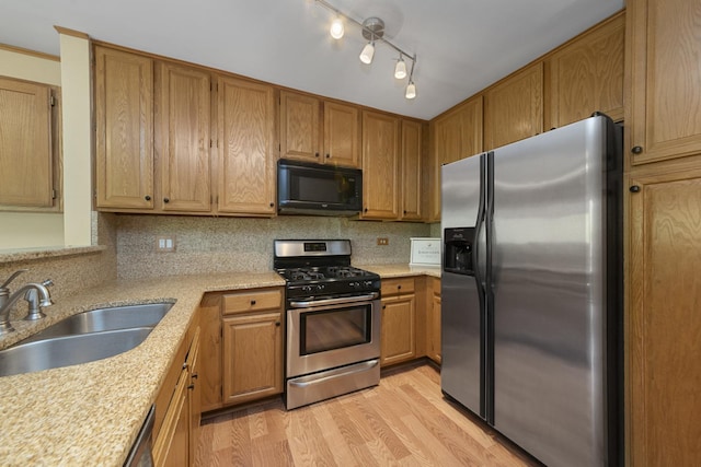22W128 Butterfield Rd, Glen Ellyn, IL 60137 - kitchen with stainless steel appliances, a sink, light wood-type flooring, and backsplash