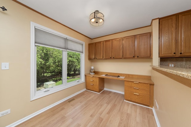 22W128 Butterfield Rd, Glen Ellyn, IL 60137 - unfurnished office with built in desk, light wood finished floors, baseboards, and crown molding
